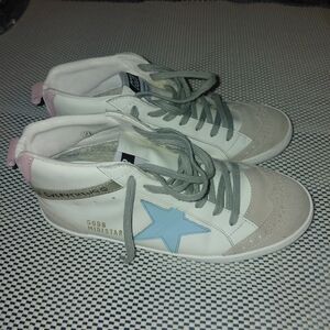 Golden Goose Mid Star sneakers with a white leather upper, light blue star